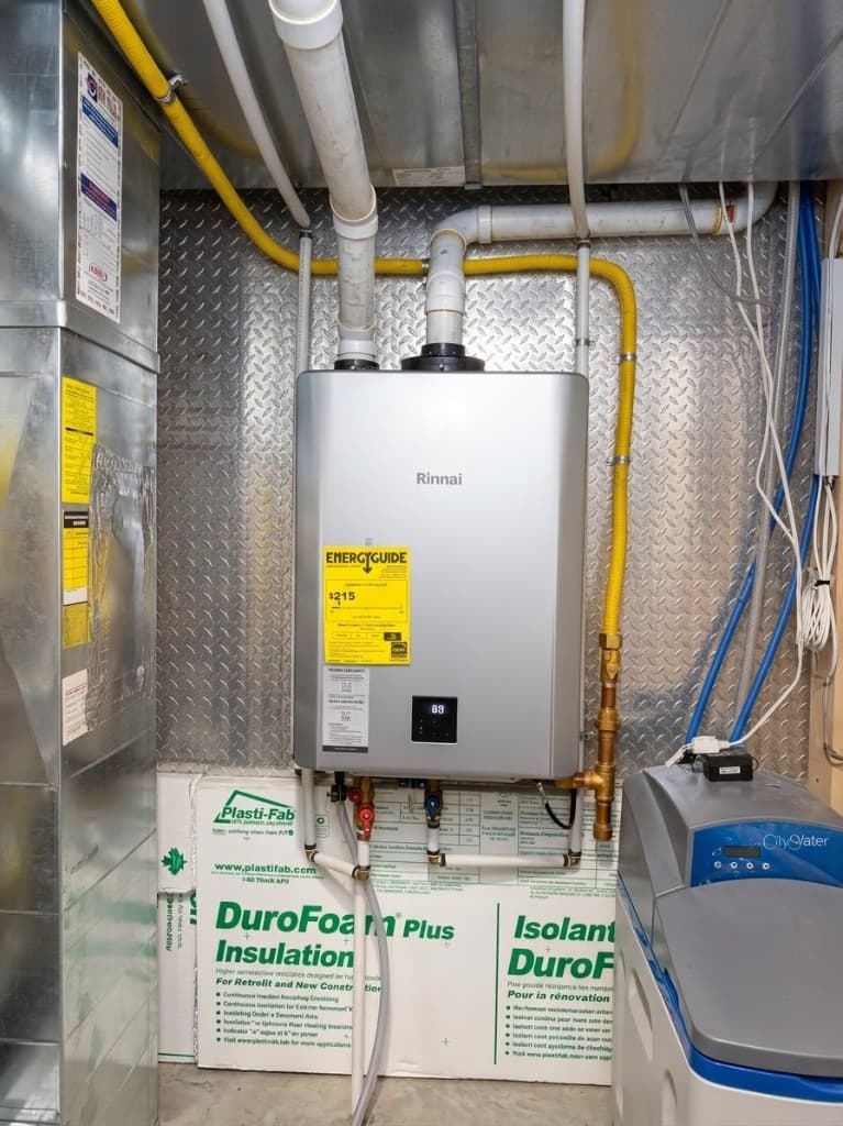 Rinnai tankless water heater installed in a basement mechanical room