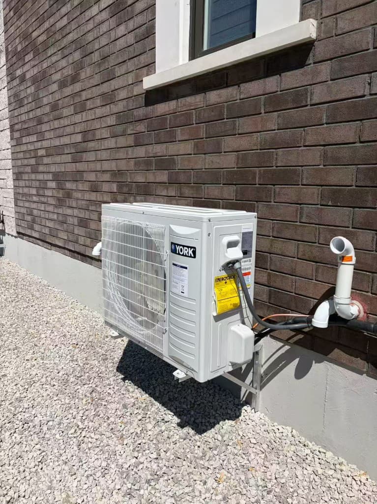 York side-discharge air conditioner installed on a brick home
